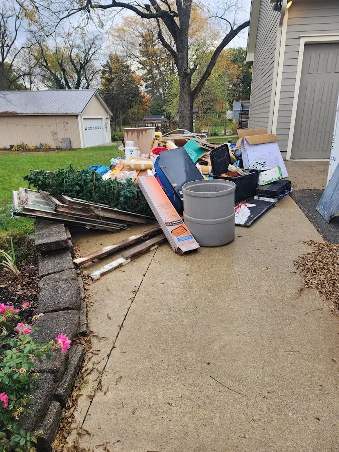 Dumpster being loaded with debris for Commercial Dumpster Rental in Cottage Grove